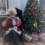 Murder at Mistletoe Mall - Mrs. "Claws" adjusts her cleavage on Santa's Throne